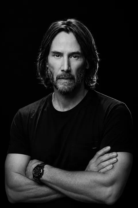 Keanu Reeves — monochrome crossed-arms studio portrait, AI-generated