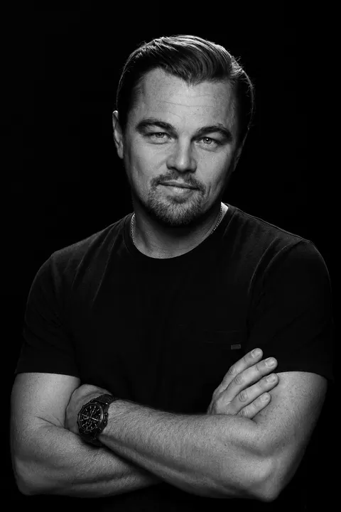 Leonardo DiCaprio — monochrome crossed-arms studio portrait, AI-generated