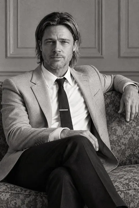 Brad Pitt — monochrome seated portrait on a vintage sofa, AI-generated