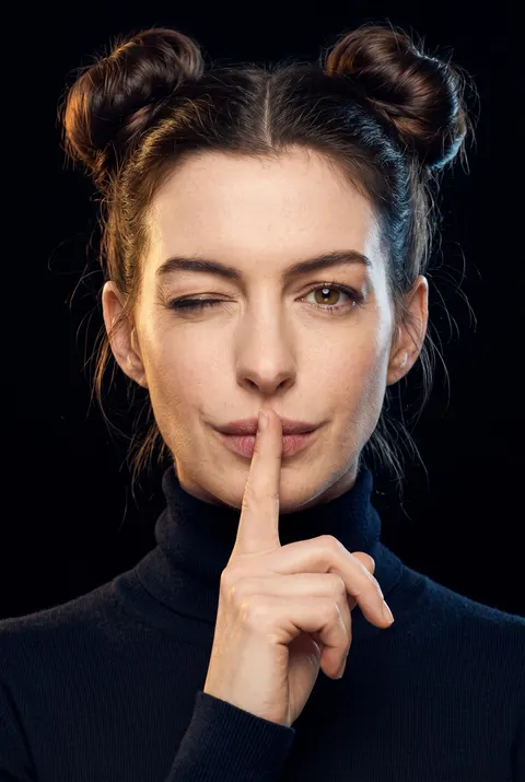 Anne Hathaway — shh wink portrait with space buns, AI-generated