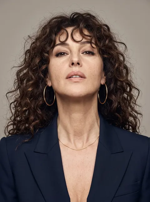 Monica Bellucci — voluminous curls and navy blazer portrait, AI-generated