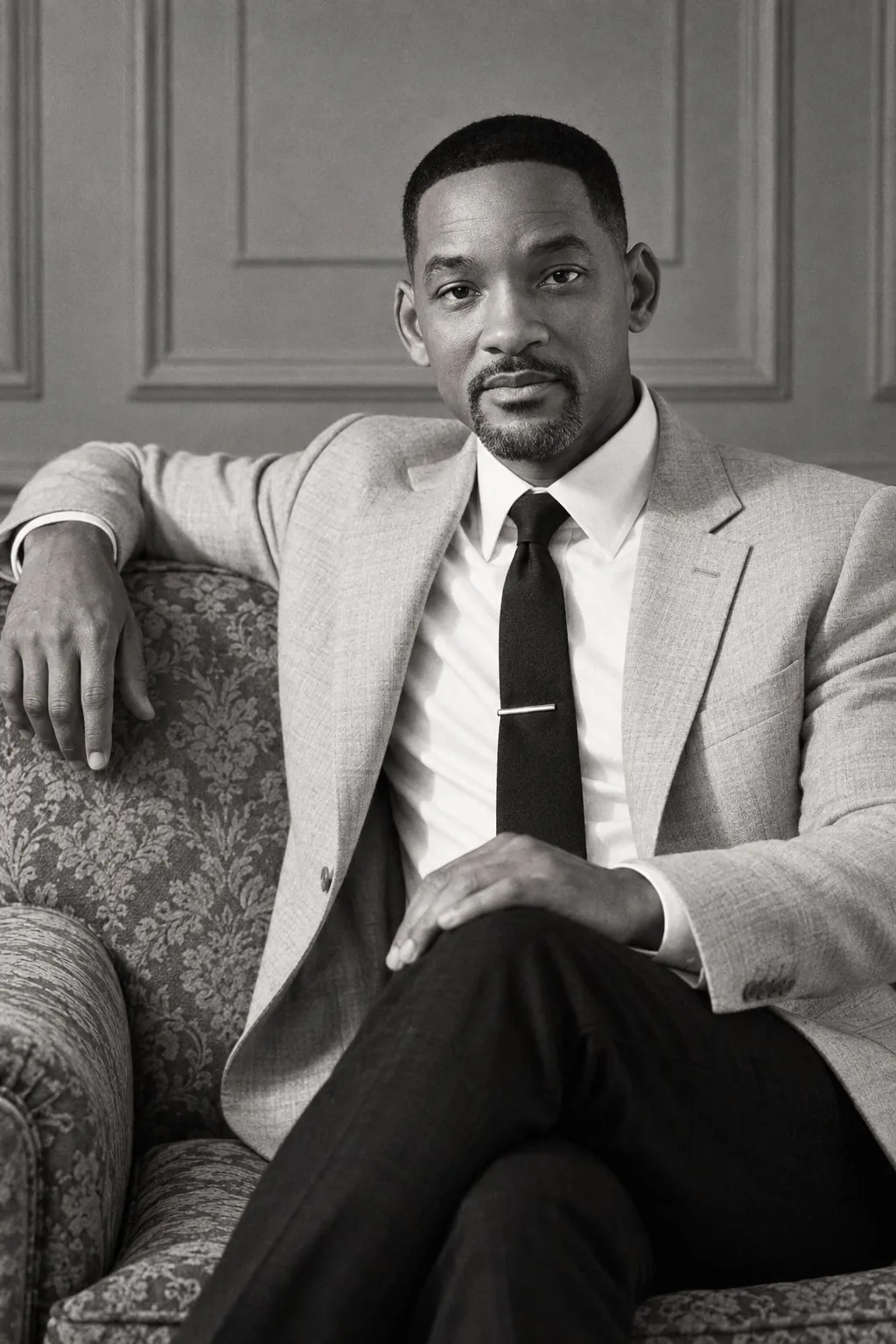 Will Smith — monochrome seated portrait on a vintage sofa, AI-generated