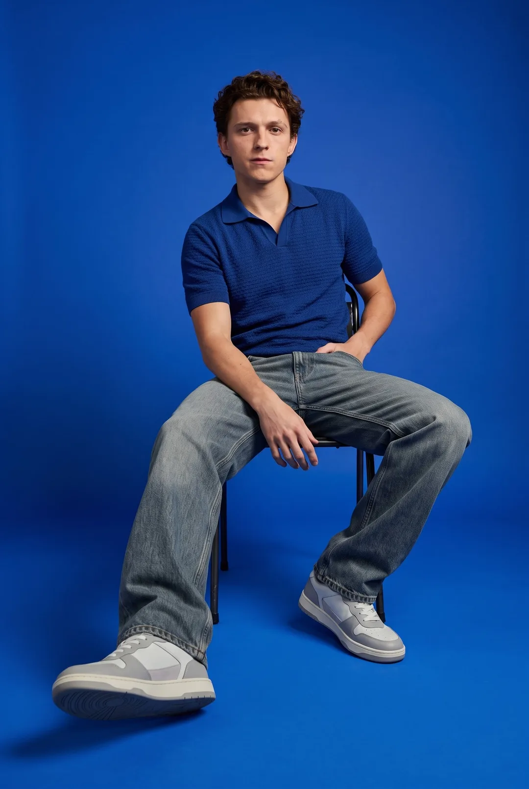 Tom Holland — royal blue streetwear seated portrait, AI-generated